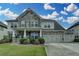 Charming two-story home featuring stone accents, a three-car garage, and beautifully landscaped front yard at 1200 Bar Harbor Pl, Lawrenceville, GA 30044