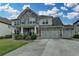 Charming two-story home featuring stone accents, a three-car garage, and beautifully landscaped front yard at 1200 Bar Harbor Pl, Lawrenceville, GA 30044