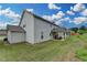 Home exterior showcasing the well-manicured backyard, covered patio, and siding at 1200 Bar Harbor Pl, Lawrenceville, GA 30044
