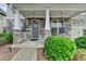 Welcoming front porch with stone accents, elegant columns, and beautiful landscaping creating curb appeal at 1200 Bar Harbor Pl, Lawrenceville, GA 30044