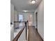 Well-lit upstairs hallway with hardwood floors and white trim, connecting various rooms in the home at 1200 Bar Harbor Pl, Lawrenceville, GA 30044