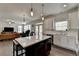Open layout kitchen offers white cabinetry, stainless appliances, and a view into the adjacent living area at 1200 Bar Harbor Pl, Lawrenceville, GA 30044