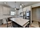 Bright kitchen features white cabinets, stainless steel appliances, and a large center island with quartz countertop at 1200 Bar Harbor Pl, Lawrenceville, GA 30044