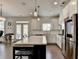 Kitchen with white cabinets, stainless steel appliances, and an island, seamlessly connected to the living area at 1200 Bar Harbor Pl, Lawrenceville, GA 30044