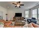 Open living space featuring a ceiling fan, hardwood floors, and natural light at 1200 Bar Harbor Pl, Lawrenceville, GA 30044