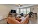 Spacious living room with ceiling fan, large sectional, and plenty of natural light at 1200 Bar Harbor Pl, Lawrenceville, GA 30044