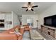 Bright living room featuring a brown leather sectional and hardwood floors at 1200 Bar Harbor Pl, Lawrenceville, GA 30044