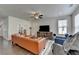 Sun-drenched living room boasts hardwood floors, natural light, and comfortable seating at 1200 Bar Harbor Pl, Lawrenceville, GA 30044