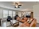 Cozy living room with large windows and a comfortable leather sectional sofa at 1200 Bar Harbor Pl, Lawrenceville, GA 30044