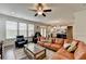 Bright living room with large windows and a comfortable leather sectional sofa at 1200 Bar Harbor Pl, Lawrenceville, GA 30044