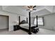 Comfortable main bedroom with a tray ceiling and a cozy sitting area by the bright window at 1200 Bar Harbor Pl, Lawrenceville, GA 30044