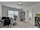 Bright home office featuring a large window, desk, chair and shelving for storage at 1200 Bar Harbor Pl, Lawrenceville, GA 30044