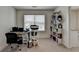Bright home office featuring a large window, desk, chair and shelving for storage at 1200 Bar Harbor Pl, Lawrenceville, GA 30044