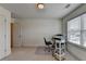 Bright home office featuring a large window, desk, chair and shelving for storage at 1200 Bar Harbor Pl, Lawrenceville, GA 30044