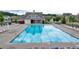 Community pool with lounge chairs and a clubhouse, providing a relaxing recreational space at 1200 Bar Harbor Pl, Lawrenceville, GA 30044