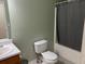 Bathroom with a single sink vanity and a shower with a gray curtain at 279 Fairview Dr, Dallas, GA 30157