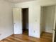 This cozy bedroom features wood floors, white walls, and two closets at 279 Fairview Dr, Dallas, GA 30157