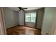 Bedroom with hardwood floors, ceiling fan, and a large window with natural light at 279 Fairview Dr, Dallas, GA 30157