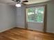A bedroom with hardwood flooring and a bright window with natural light at 279 Fairview Dr, Dallas, GA 30157
