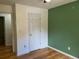 This cozy bedroom features light hardwood floors and a brightly painted accent wall at 279 Fairview Dr, Dallas, GA 30157