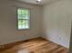 The bedroom offers neutral walls, hardwood floors, and a window that provides natural light at 279 Fairview Dr, Dallas, GA 30157