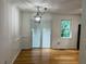The dining room includes a modern light fixture, sliding glass doors, and a large window at 279 Fairview Dr, Dallas, GA 30157