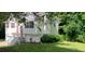 Charming home with lush landscaping, a red front door, and a two car garage at 279 Fairview Dr, Dallas, GA 30157