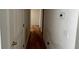 Hallway with hardwood floors and neutral paint, leading to rooms in the home at 279 Fairview Dr, Dallas, GA 30157