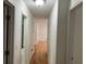 Well-lit hallway featuring wood floors and access to multiple rooms at 279 Fairview Dr, Dallas, GA 30157