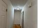 Hallway illuminated by overhead lighting and featuring white walls leading to other rooms at 279 Fairview Dr, Dallas, GA 30157