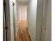 Hallway featuring hardwood floors, white walls, and access to the bedrooms at 279 Fairview Dr, Dallas, GA 30157