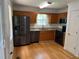 Galley kitchen with stainless appliances, wood cabinets, a double sink and flooring at 279 Fairview Dr, Dallas, GA 30157