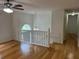 Bright, open living area with hardwood floors and staircase, illuminated by hanging fixture at 279 Fairview Dr, Dallas, GA 30157