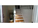Staircase featuring hardwood steps and white railings, leading to the upper level of the home at 279 Fairview Dr, Dallas, GA 30157