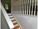 Stairway leads to the upper level with white painted railing and hardwood steps at 279 Fairview Dr, Dallas, GA 30157