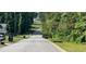 Street view of a road in a residential neighborhood with mature trees and landscaping at 279 Fairview Dr, Dallas, GA 30157