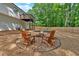 Inviting backyard fire pit with Adirondack chairs, with a lovely deck overhead and a wooded backdrop at 4053 Five Oaks Ct, Powder Springs, GA 30127