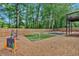 Large backyard with lush green space and various games, surrounded by a wood fence for privacy at 4053 Five Oaks Ct, Powder Springs, GA 30127