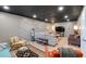 Spacious basement living room featuring tile flooring, decorative wall, and entertainment setup at 4053 Five Oaks Ct, Powder Springs, GA 30127
