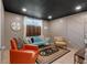 Comfortable basement living area with colorful seating, decorative rug, and natural light at 4053 Five Oaks Ct, Powder Springs, GA 30127