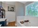 Serene bathroom features a soaking tub, decorative wallpaper, and ample natural light at 4053 Five Oaks Ct, Powder Springs, GA 30127