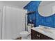 Charming bathroom featuring blue patterned wallpaper, white shower curtain, and modern vanity at 4053 Five Oaks Ct, Powder Springs, GA 30127