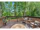 Cozy deck with rocking chairs, wood railing, and a view of the wooded surroundings at 4053 Five Oaks Ct, Powder Springs, GA 30127