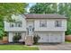 Charming two-story home featuring a well-maintained front yard and an attached two-car garage at 4053 Five Oaks Ct, Powder Springs, GA 30127