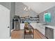 Modern kitchen with stainless steel appliances, white cabinets, and central island at 4053 Five Oaks Ct, Powder Springs, GA 30127