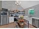 Well-lit kitchen with stainless steel appliances, custom shelves, and central island at 4053 Five Oaks Ct, Powder Springs, GA 30127