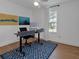 Clean home office with modern desk, natural light, and geometric rug at 4053 Five Oaks Ct, Powder Springs, GA 30127