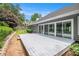 Backyard featuring mature trees, lawn and a patio/decking area at 703 Kirkwood Cir, Woodstock, GA 30189