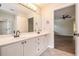 Bathroom with a double sink vanity, large mirror and view to bedroom at 703 Kirkwood Cir, Woodstock, GA 30189