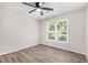 Spacious bedroom featuring hard surface floors, ceiling fan and a window for natural light at 703 Kirkwood Cir, Woodstock, GA 30189